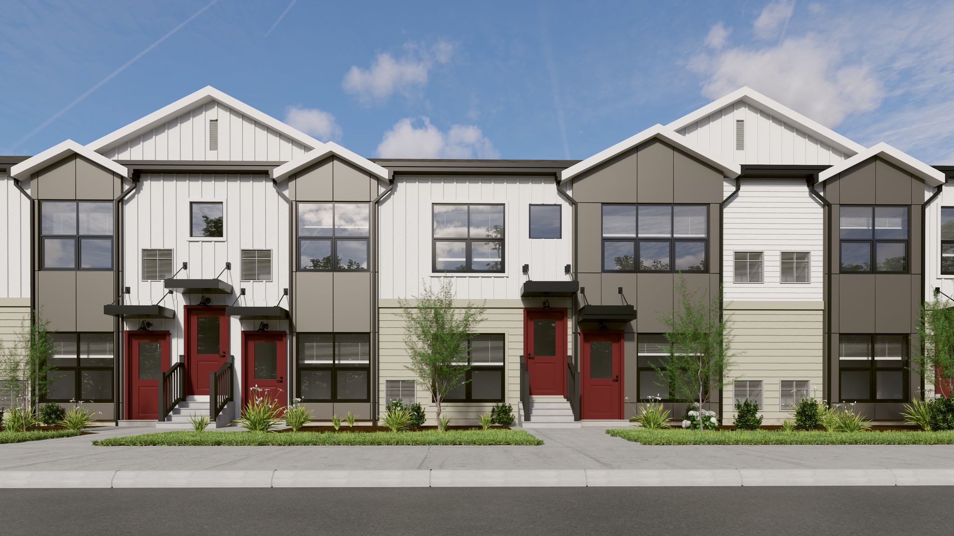 A front view of modern, multi-story townhouse units with white and grey siding, red doors, and a sidewalk in front.