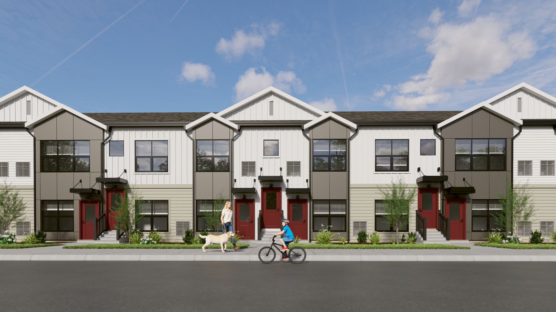 A multi-unit townhouse exterior with a white and gray facade, red doors, and a person biking on a sidewalk in front.