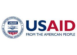 USAID logo: Blue and red text, with emblem of clasped hands and American flag.