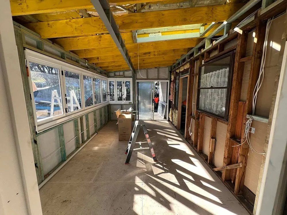 A Long Hallway With a Ladder in the Middle of It — Chandolin Construction in Bathurst, NSW