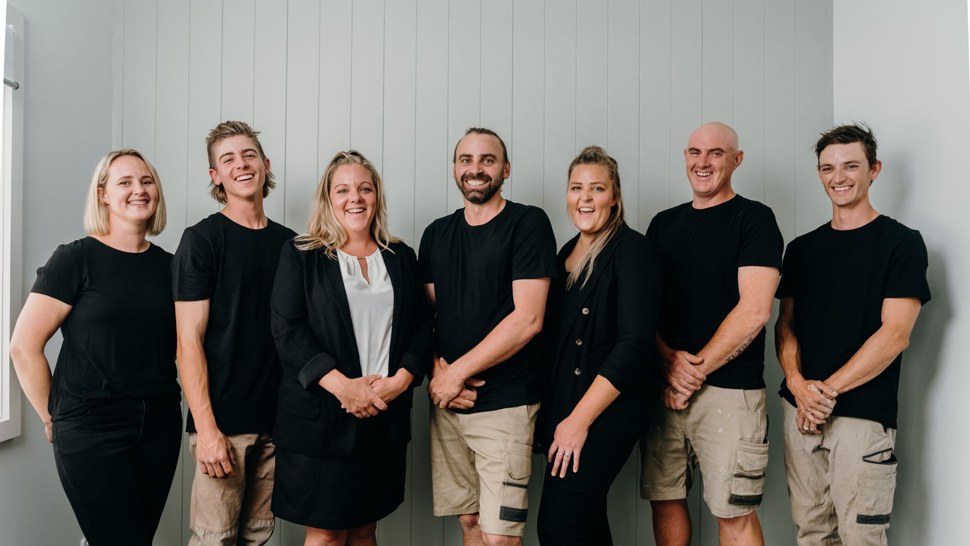 A Group of People Standing Next to Each Other in a Room — Chandolin Construction in Bathurst, NSW