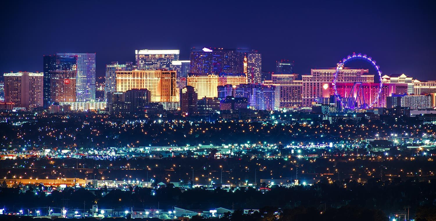 Night view of Las Vegas skyline illuminated by colorful lights.