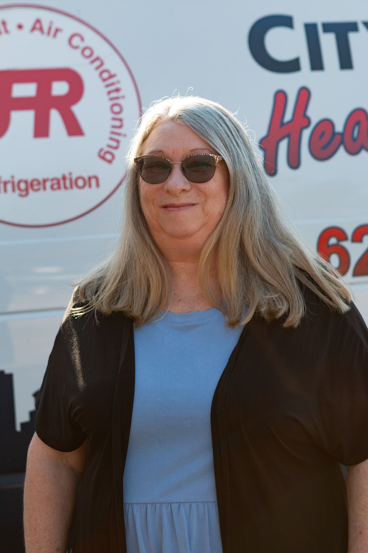 sherri standing in front of city plumbing van