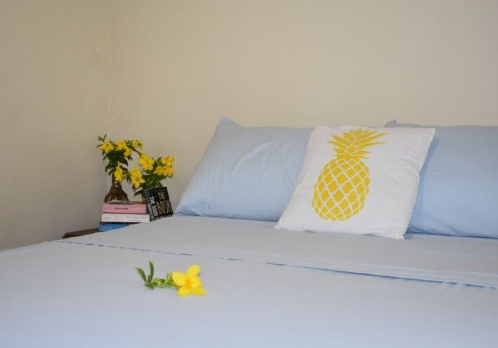 A bed with a pineapple pillow on it