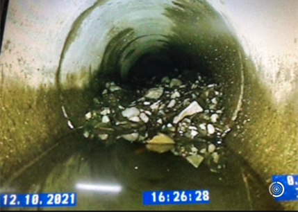 A picture of a drain with a time of 16:26 on it.