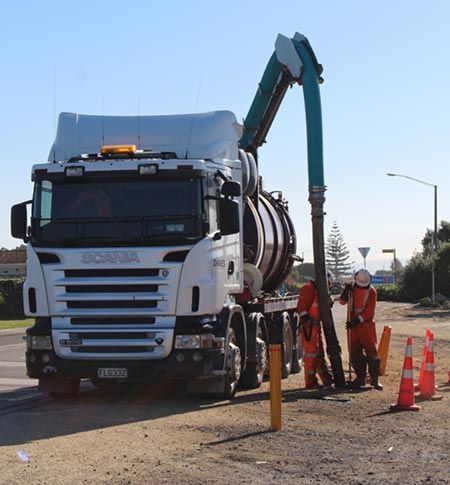 A scania truck is parked on the side of the road