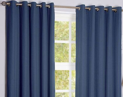 Blue curtains on a gold rail