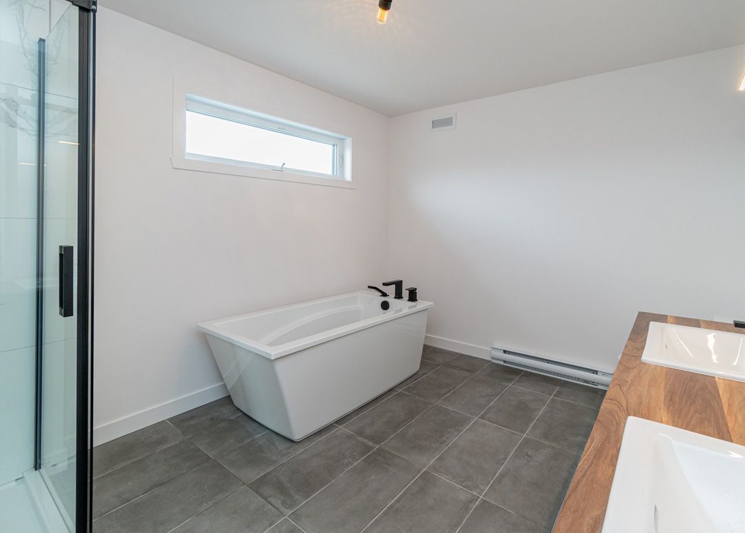 Une salle de bain avec baignoire, lavabo et douche.