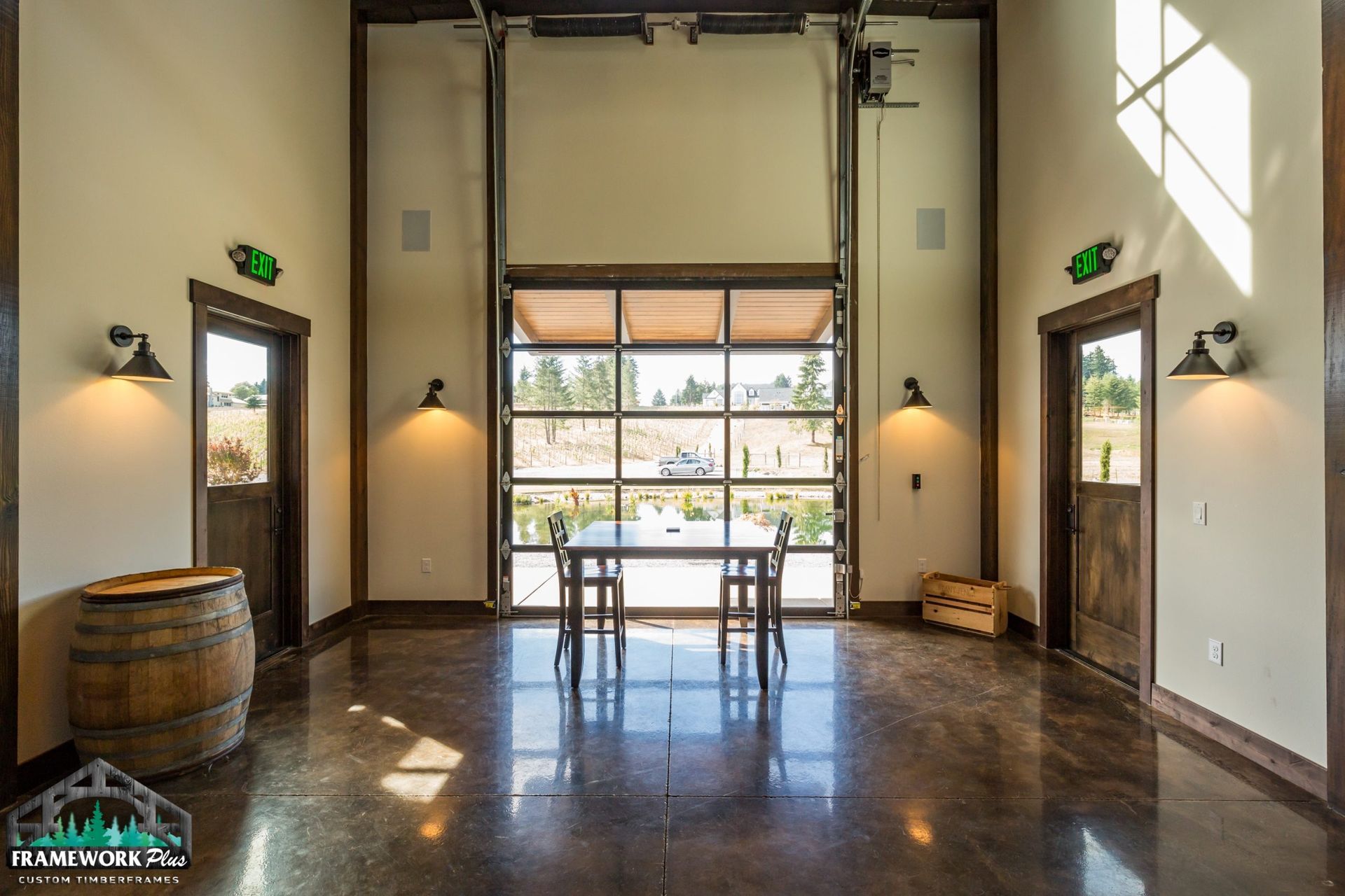 A large room with a table and chairs and a large garage door.