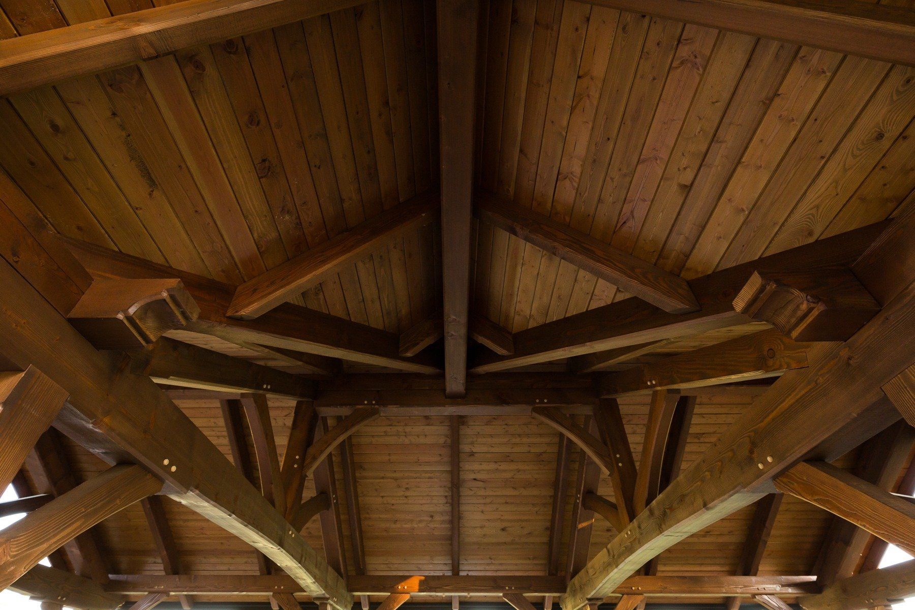 Looking up at the ceiling of a wooden structure.