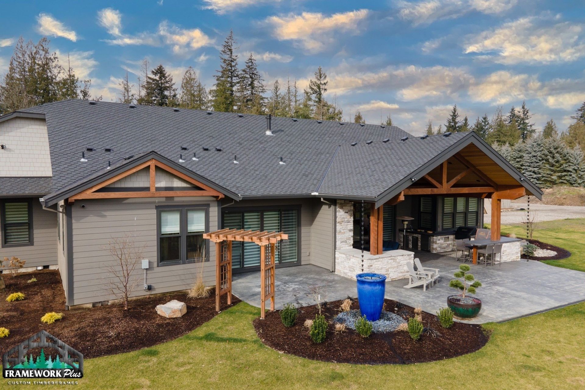 An aerial view of a house with a gray roof