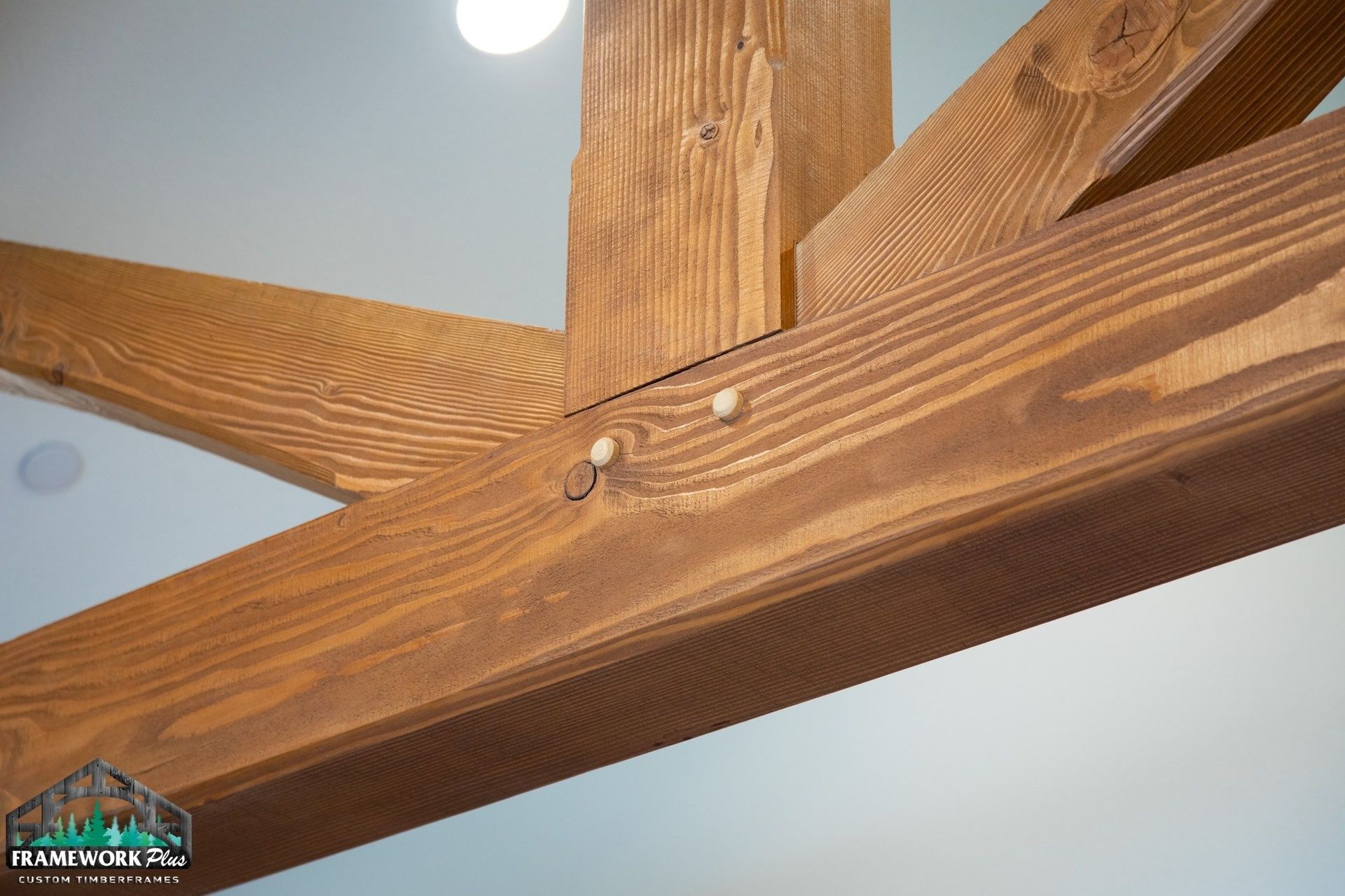 A close up of a wooden beam hanging from the ceiling.