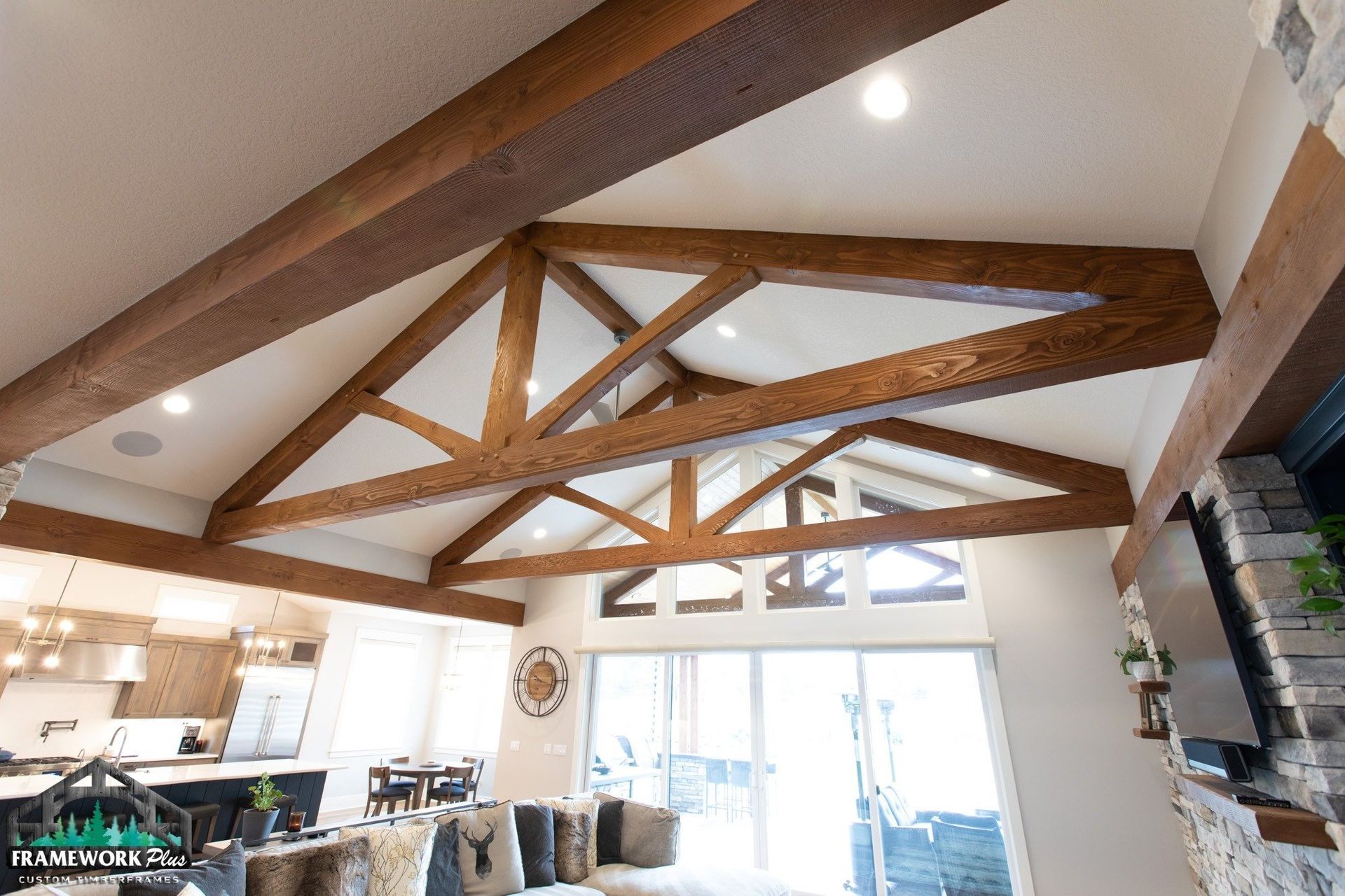 A living room with a vaulted ceiling and wooden beams.
