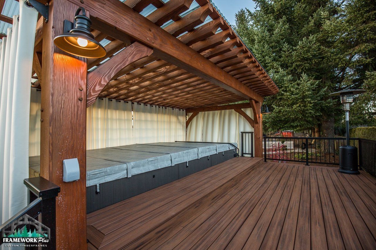 A wooden deck with a pergola over a hot tub.