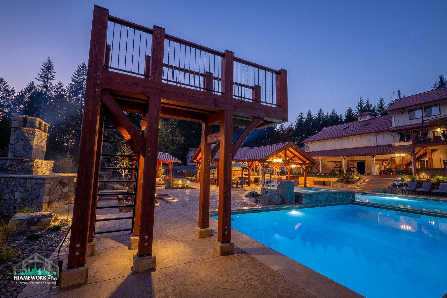 A large swimming pool with a wooden bridge over it.