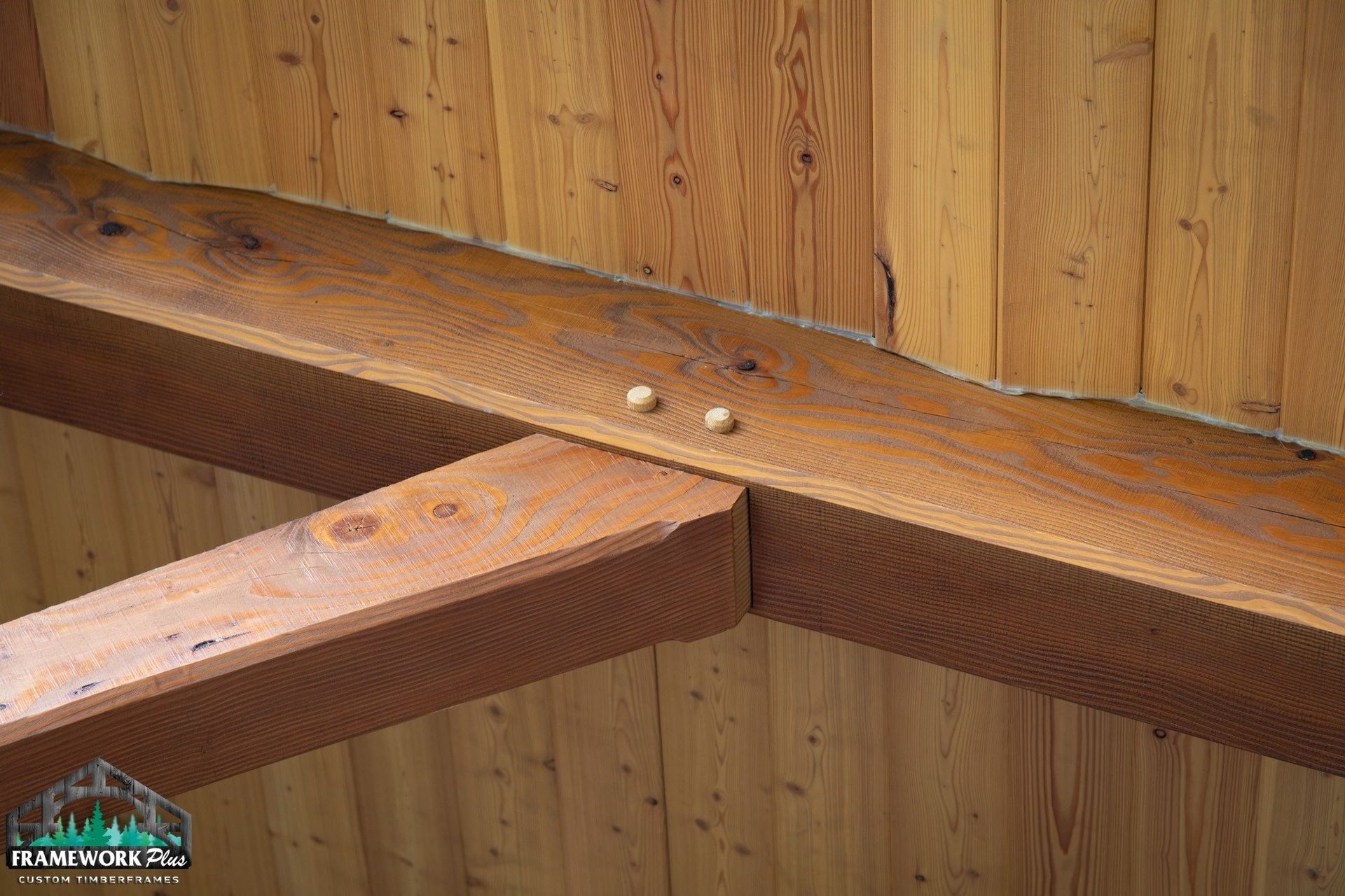 A close up of a wooden beam connected to a wooden wall.
