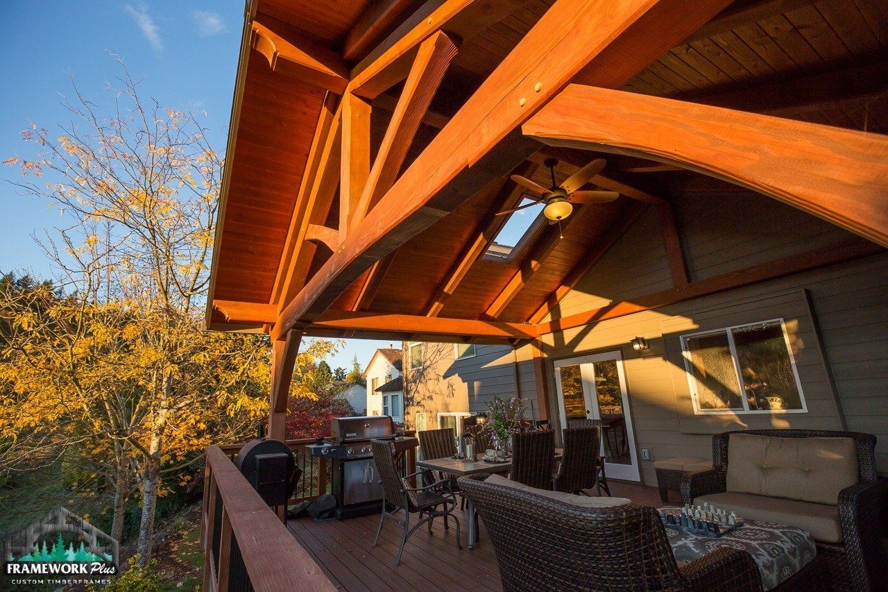 A wooden deck with furniture and a ceiling fan