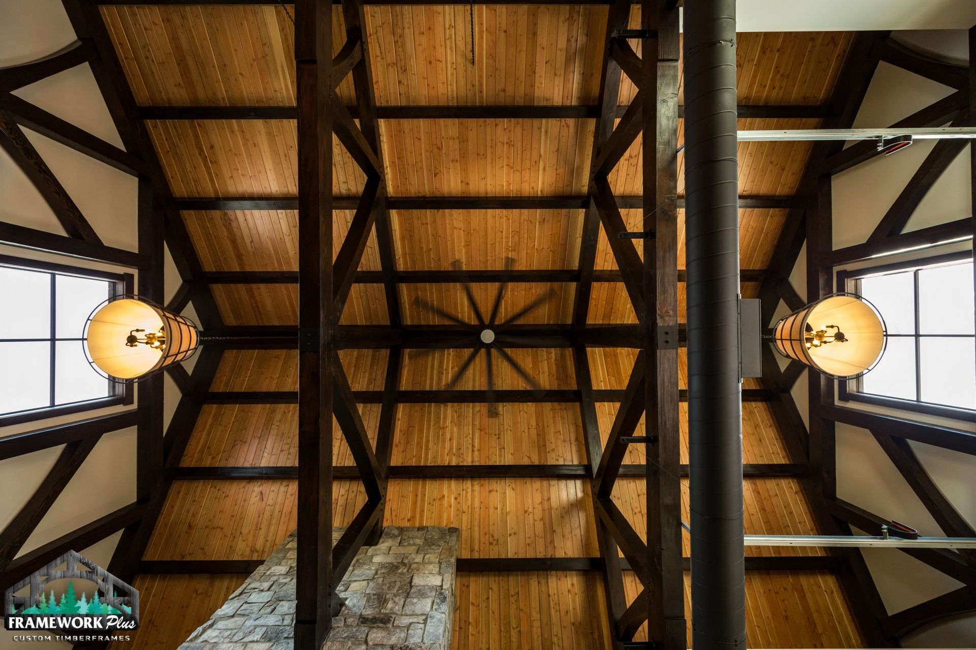 Looking up at a wooden ceiling with a ceiling fan