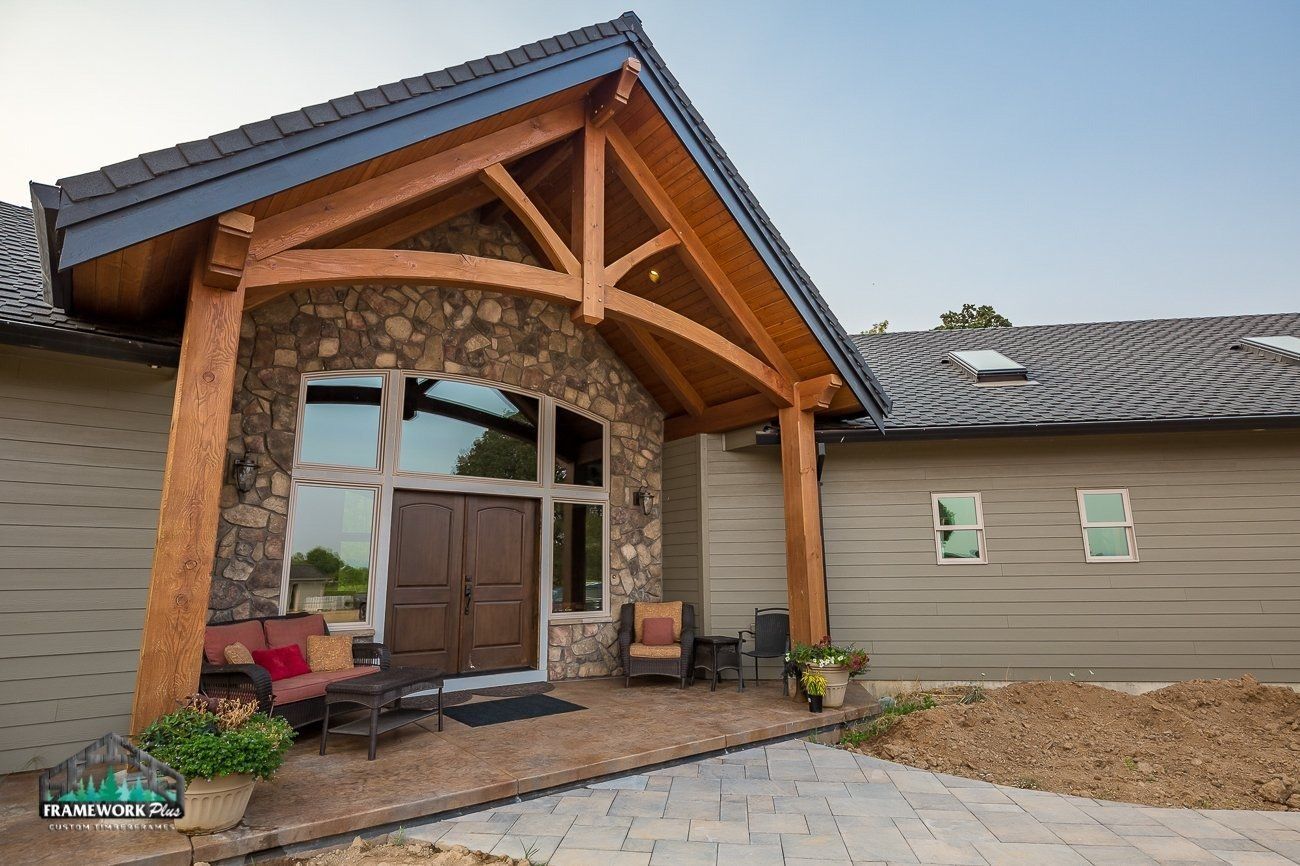 A large house with a wooden porch and a stone facade
