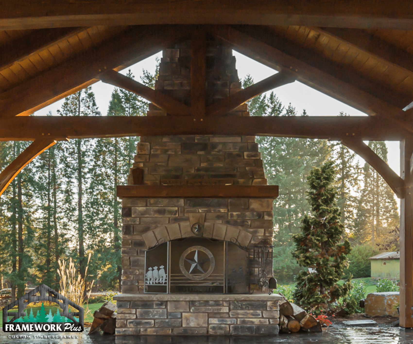 A stone fireplace under a wooden roof with a clock on it