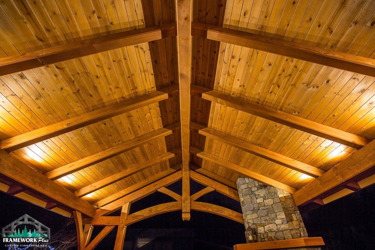 The ceiling of a wooden structure is lit up at night.