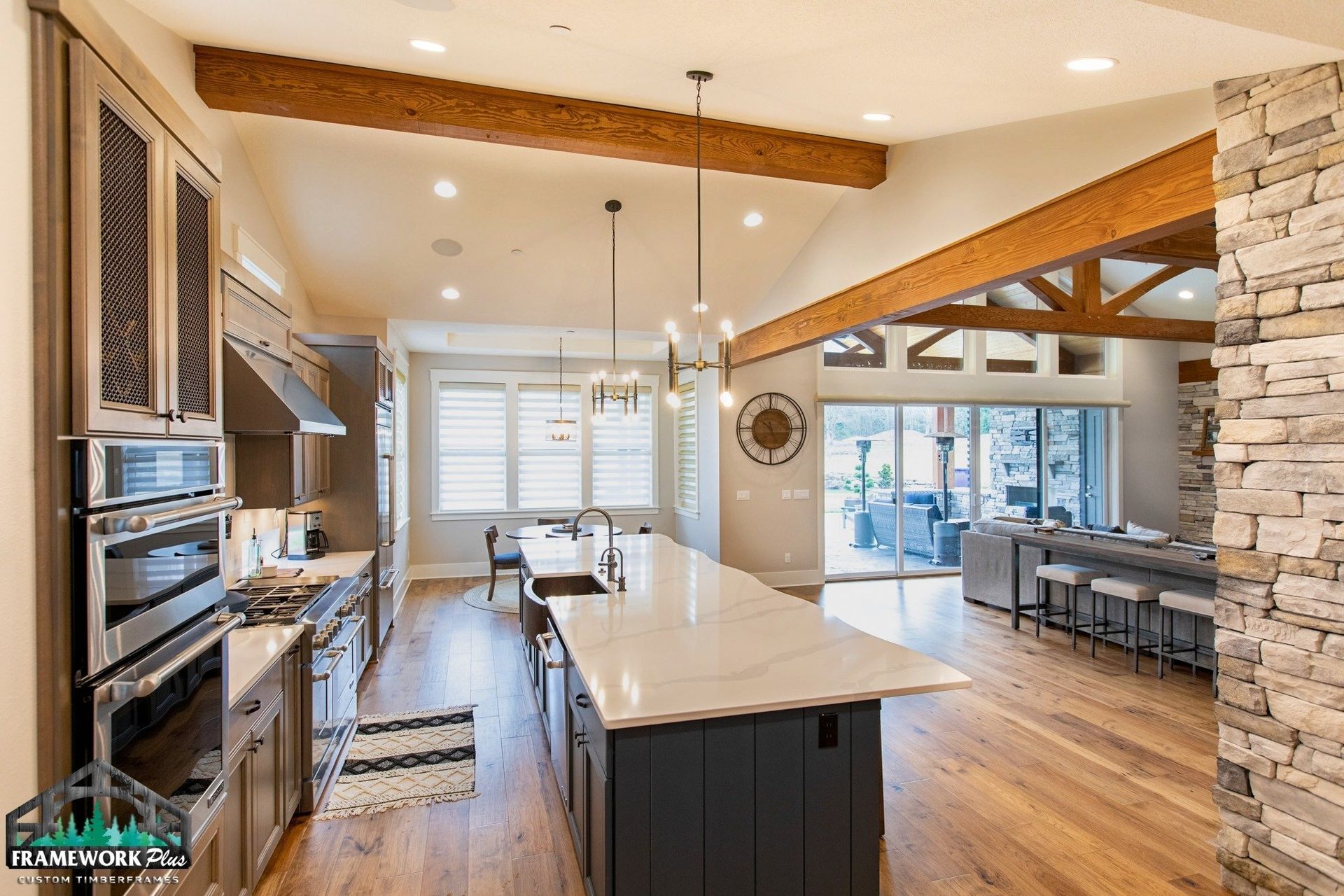 A kitchen with a large island and stainless steel appliances