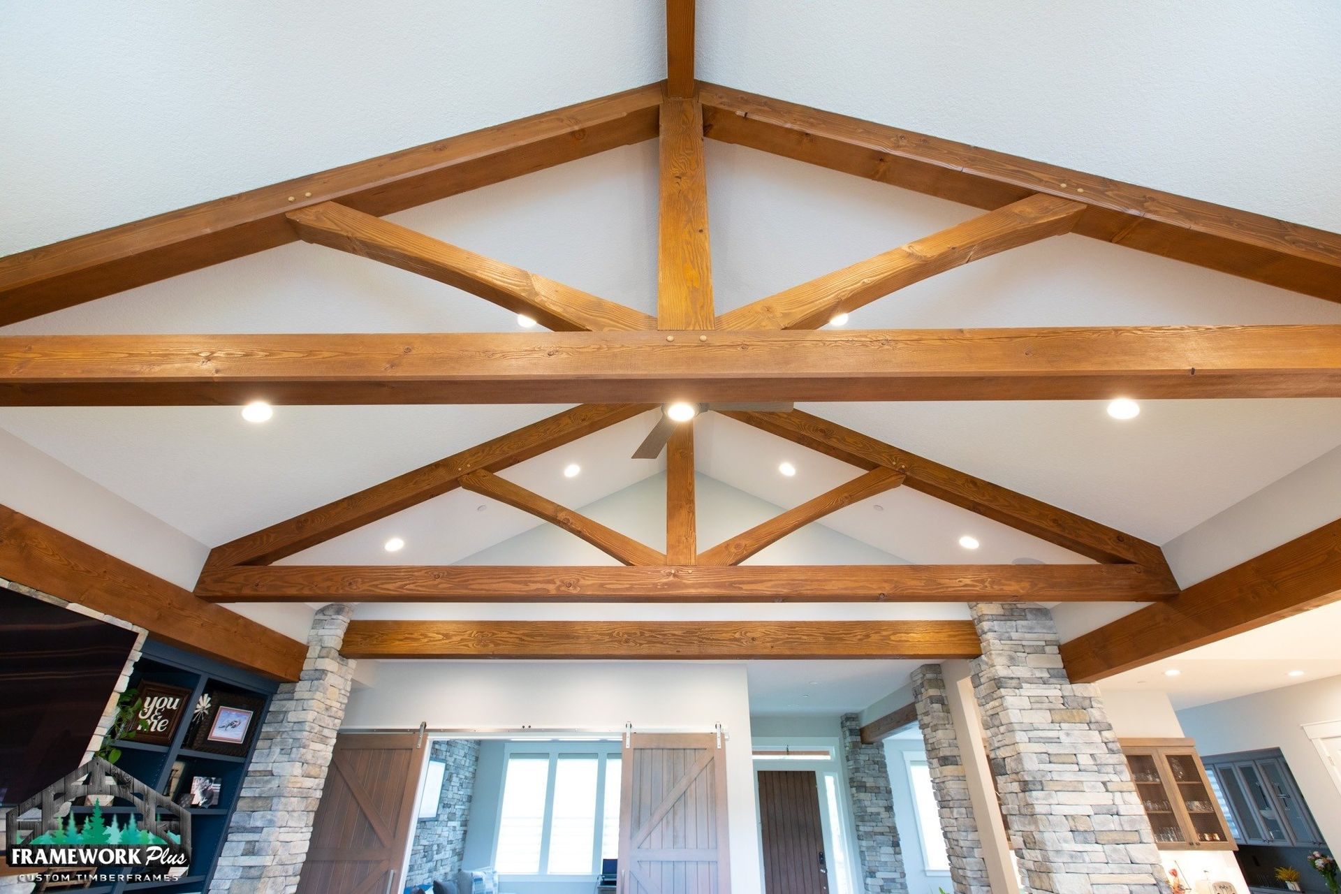 A living room with a vaulted ceiling and wooden beams.