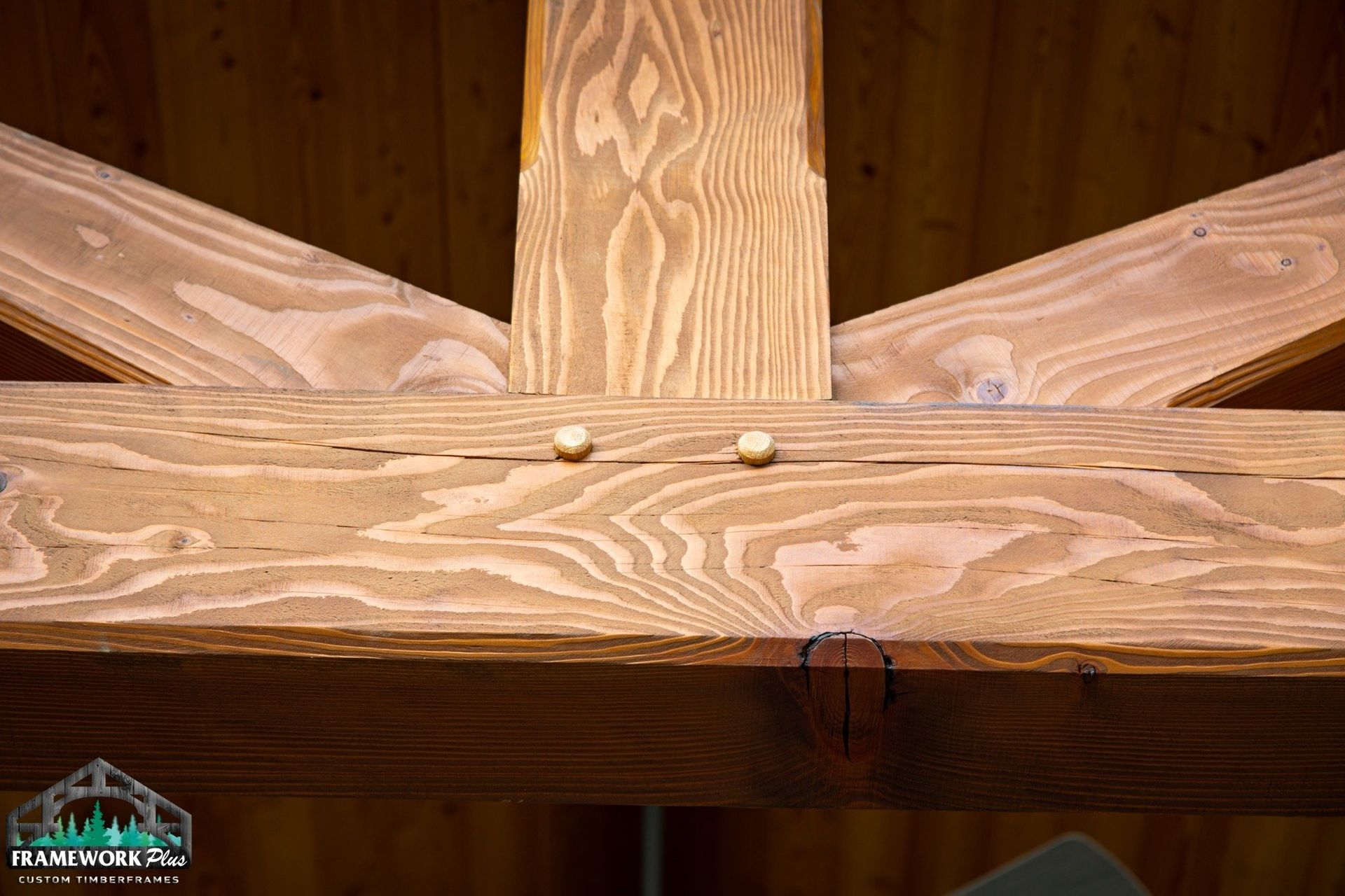 A close up of a wooden structure with screws in it.