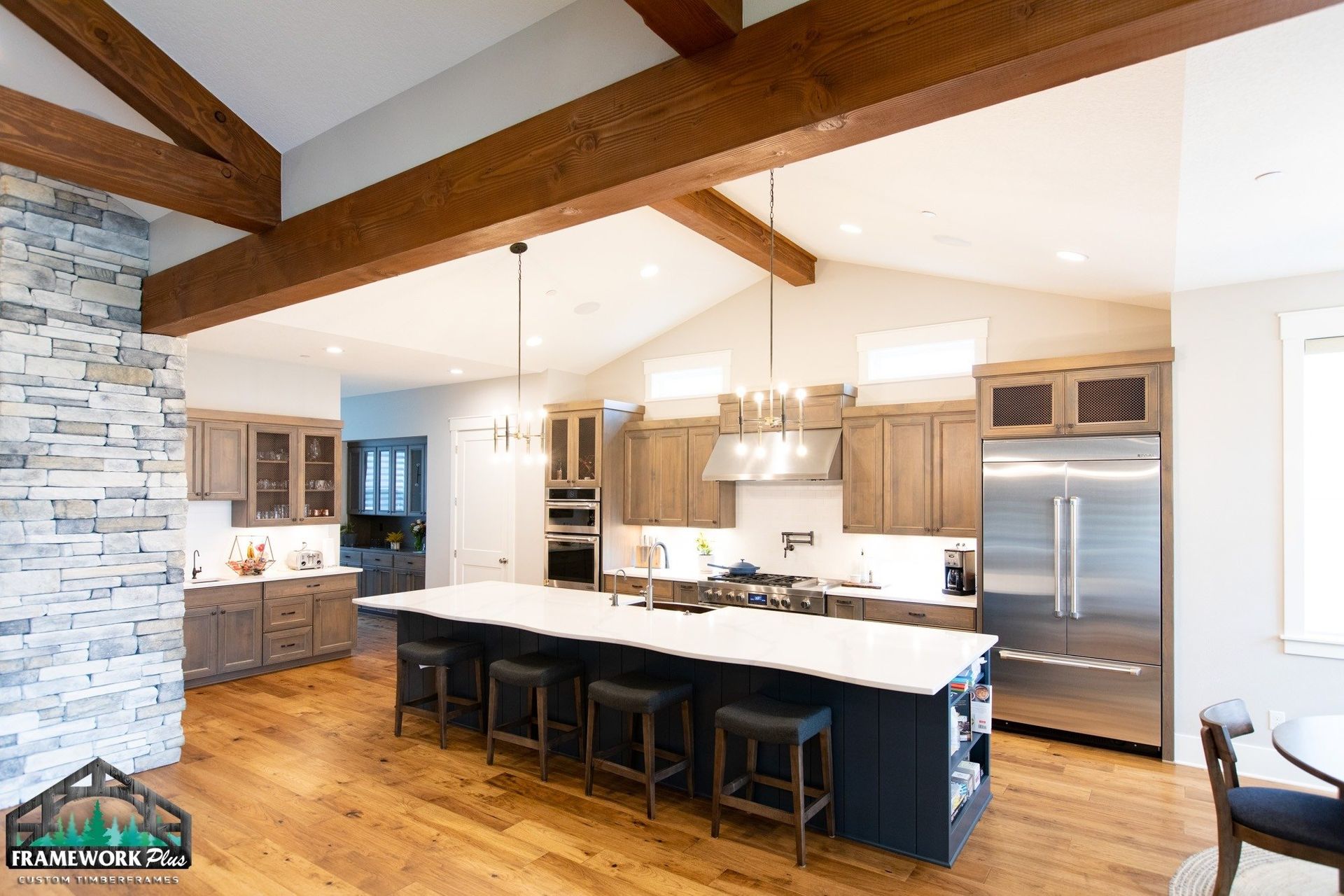 A kitchen with stainless steel appliances and a large island.