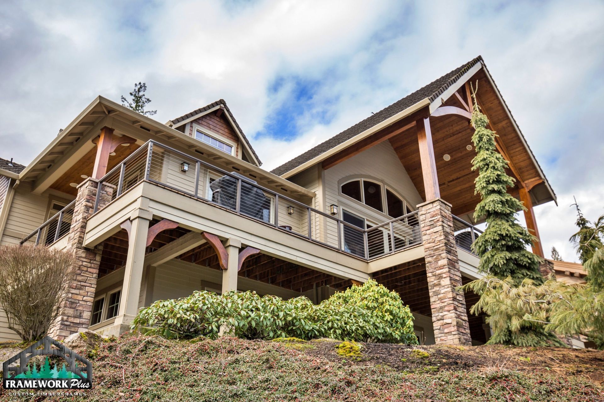 A large house with a balcony on the side of it is sitting on top of a hill.