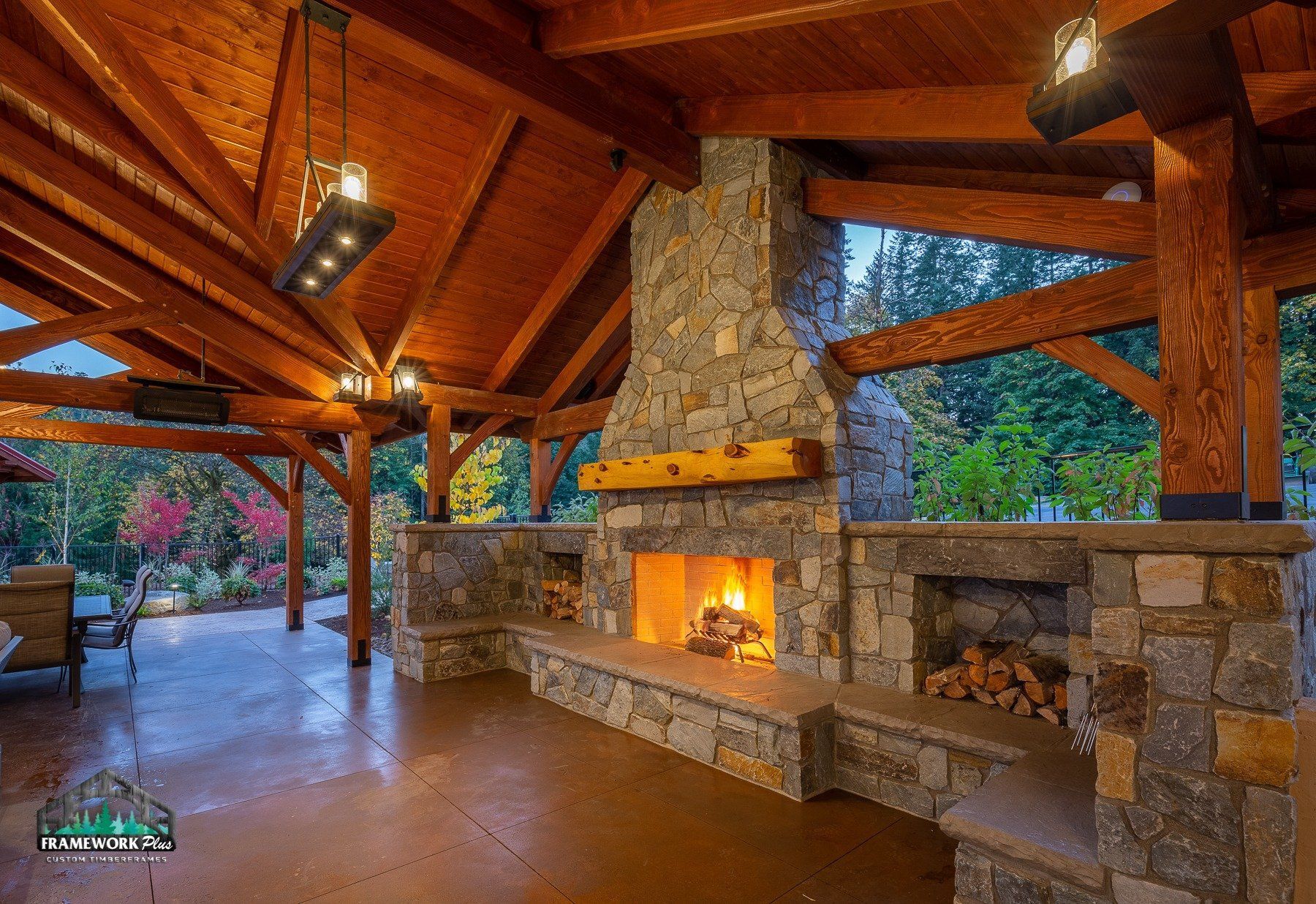 There is a large stone fireplace in the middle of the room.