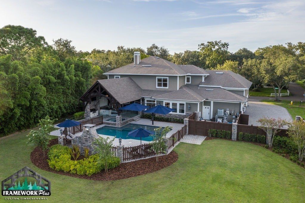 An aerial view of a large house with a swimming pool