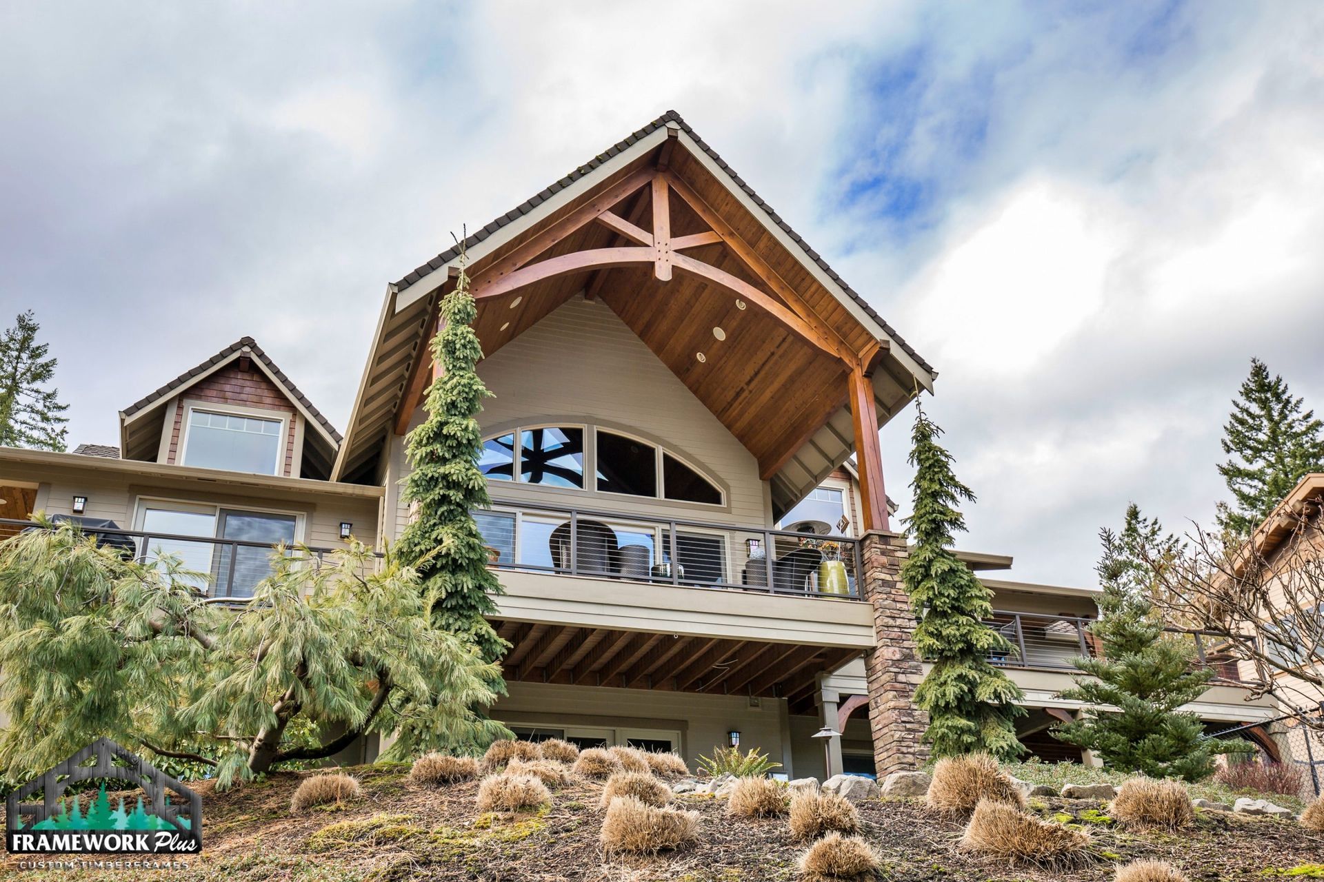 A large house is sitting on top of a hill surrounded by trees.