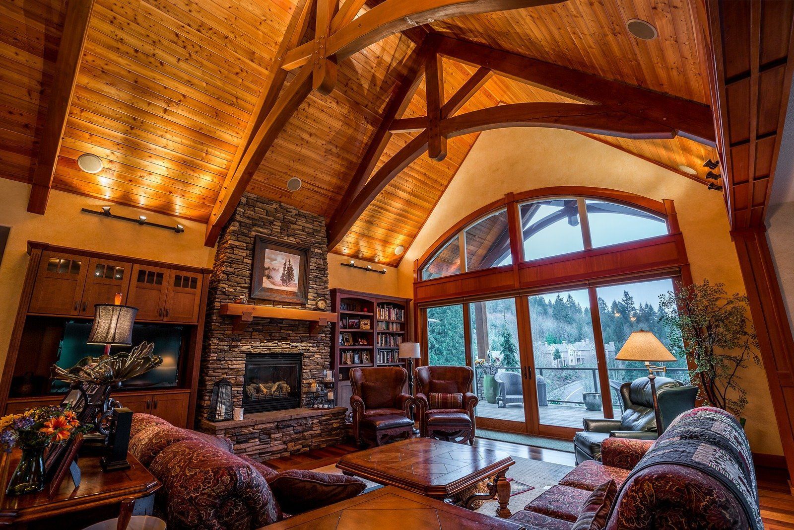 A living room with a fireplace and lots of windows