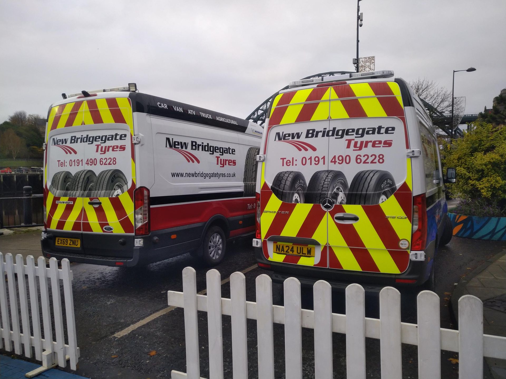 Two bridgegate tires vans are parked next to each other