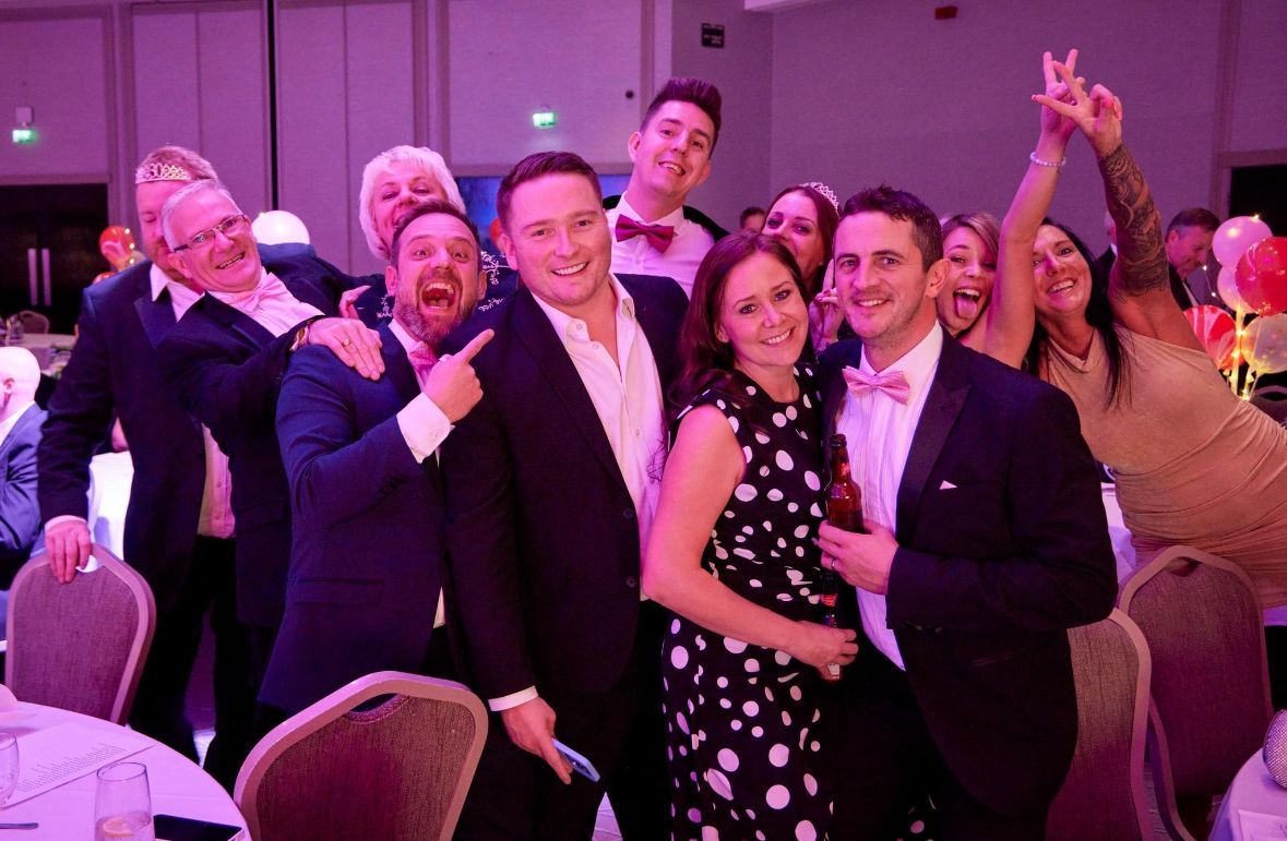 A group of people are posing for a picture at a party.