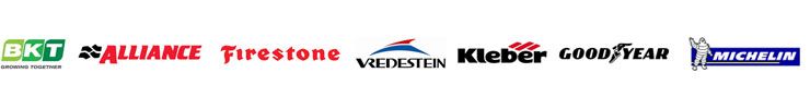 A blurred image of the logos for alliance tirestone kleber goodyear and michelin