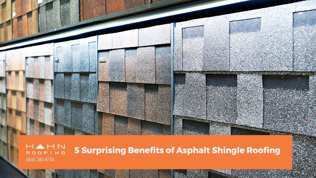 Asphalt shingle roofing samples in various colors, displayed on a rack.