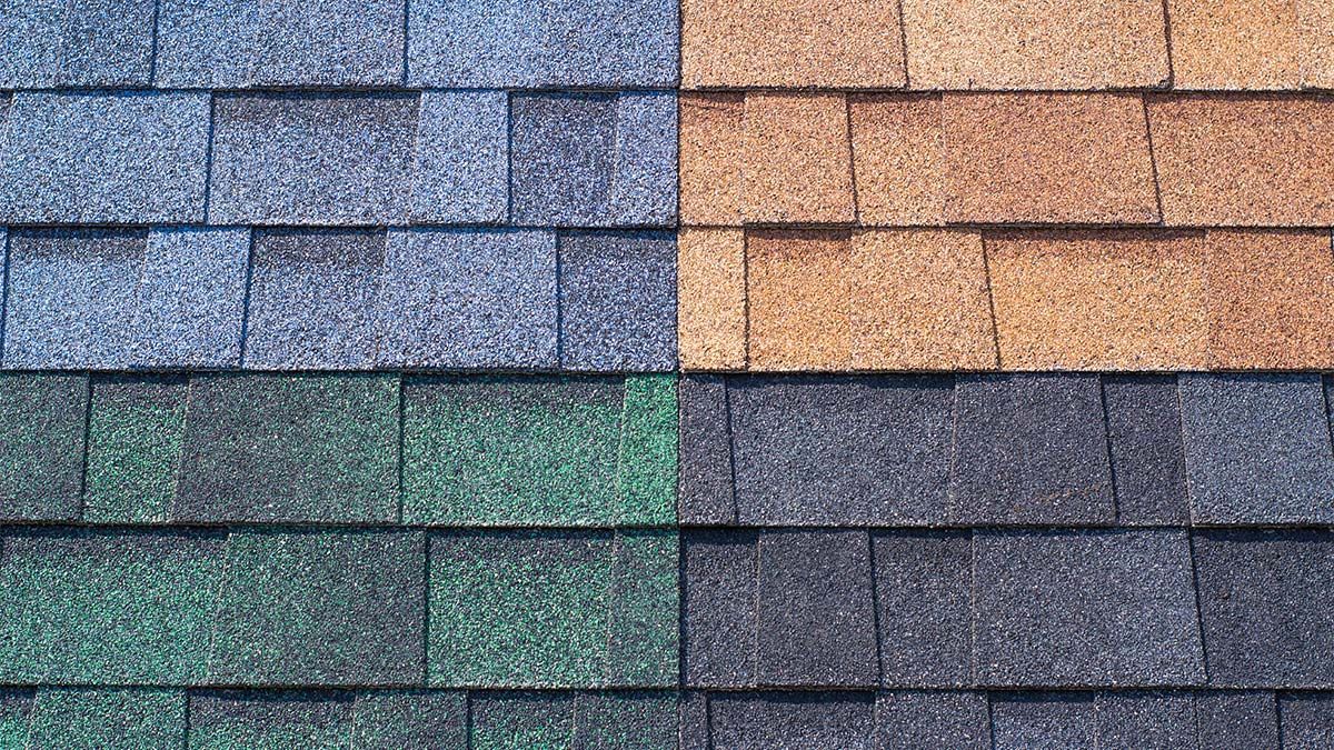 Shingles in blue, brown, green, and dark gray, showcasing roofing color options.