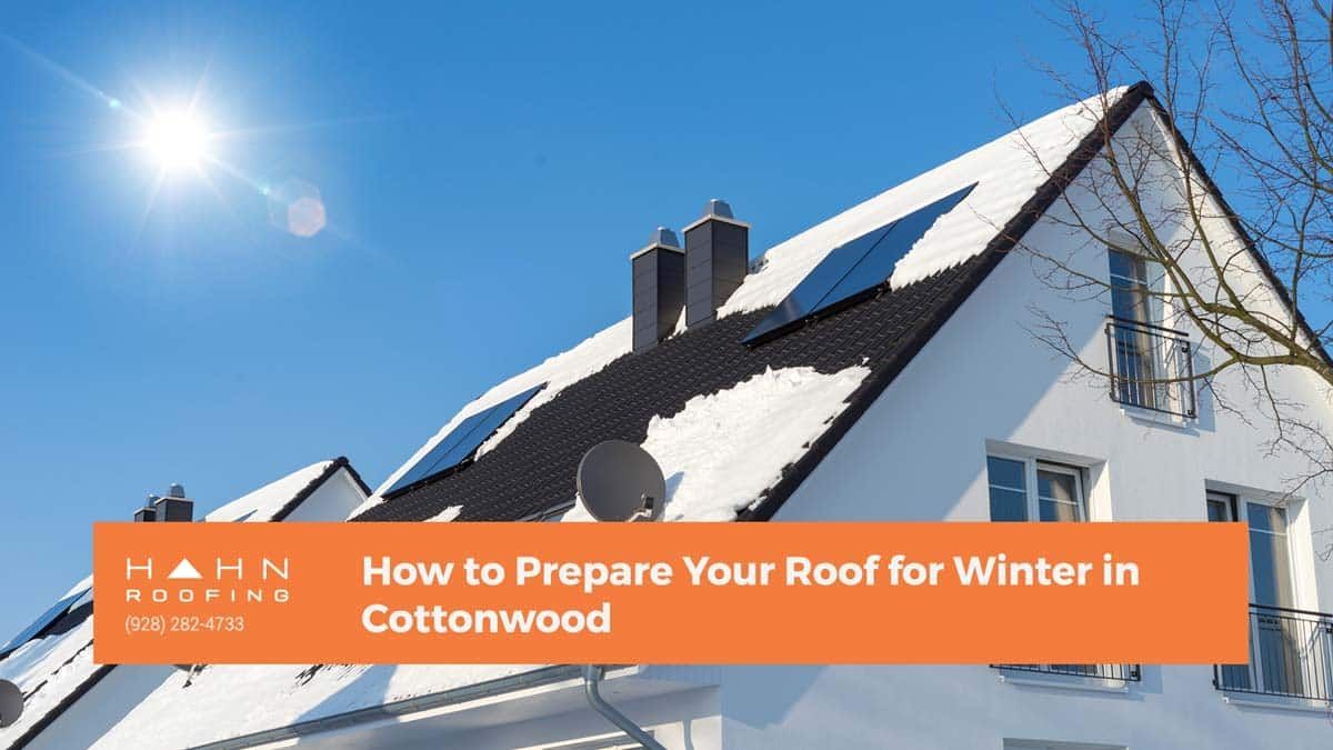 A snow-covered house roof with solar panels against a blue sky, text overlay: