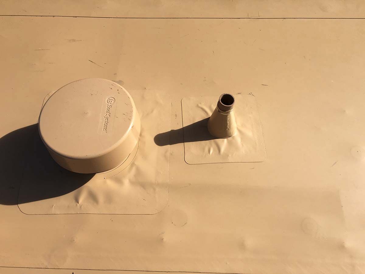 Tan surface with a round cap and a pipe protruding upwards, both with shadows.