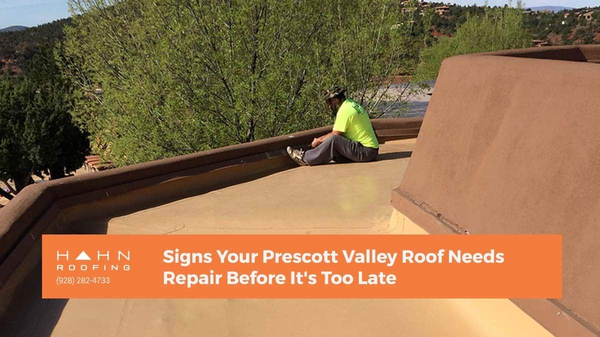 A person sits on a flat, brown roof. Text: 