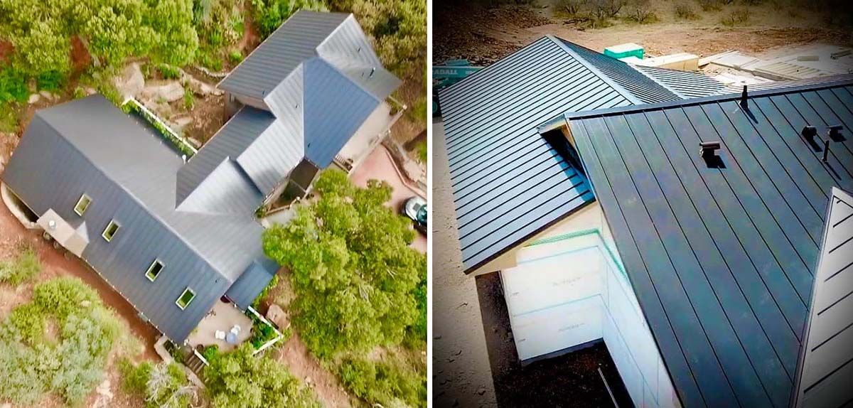 Aerial view of a home with a dark gray metal roof surrounded by greenery.