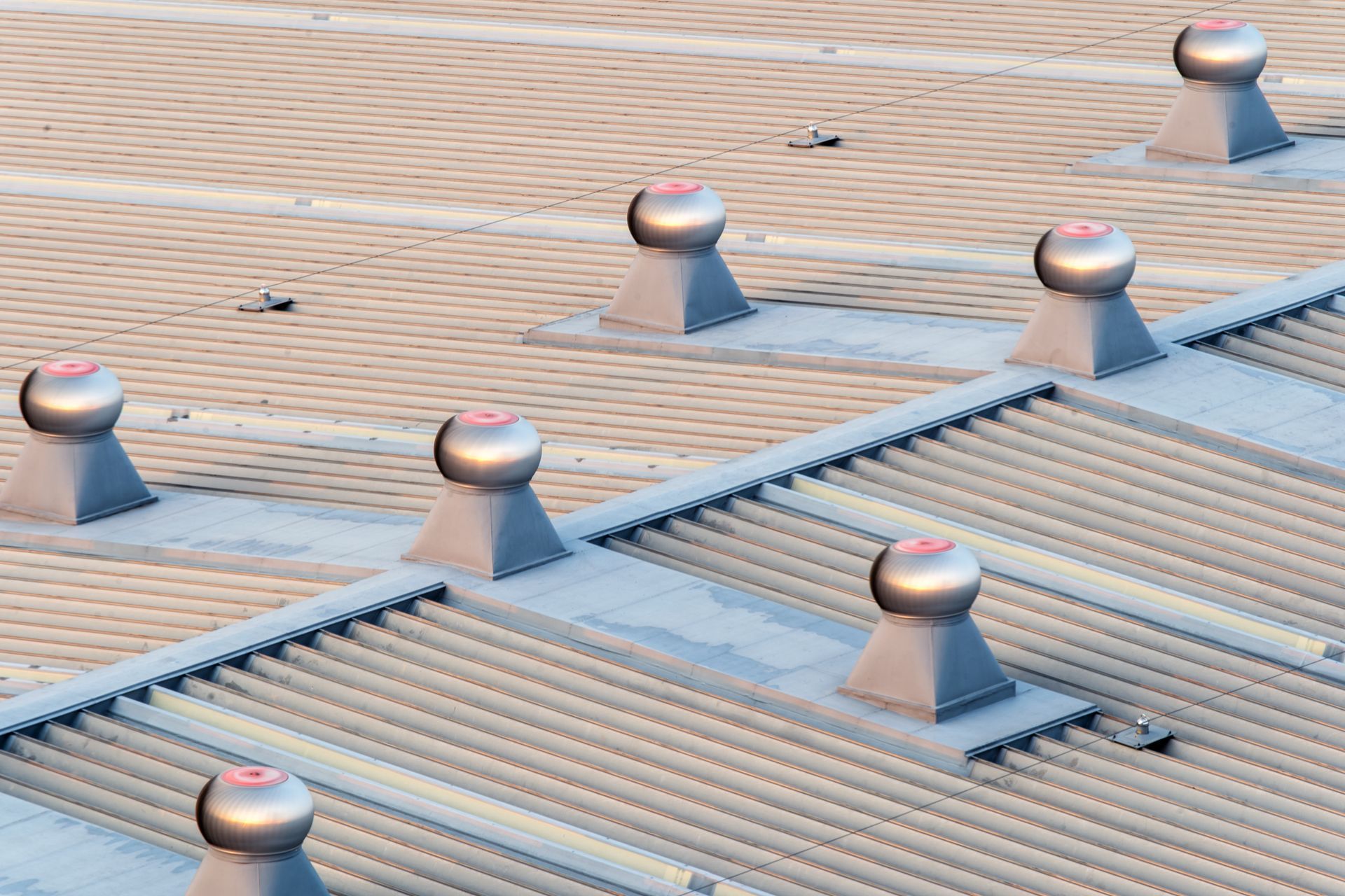 Metallic roof with several domed ventilation systems.