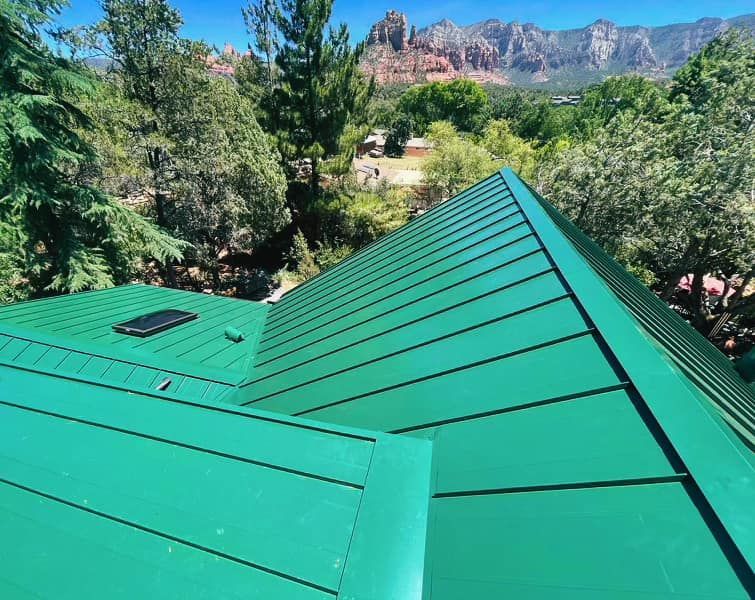 Metal flashing installed along the edge of a clay tile roof.