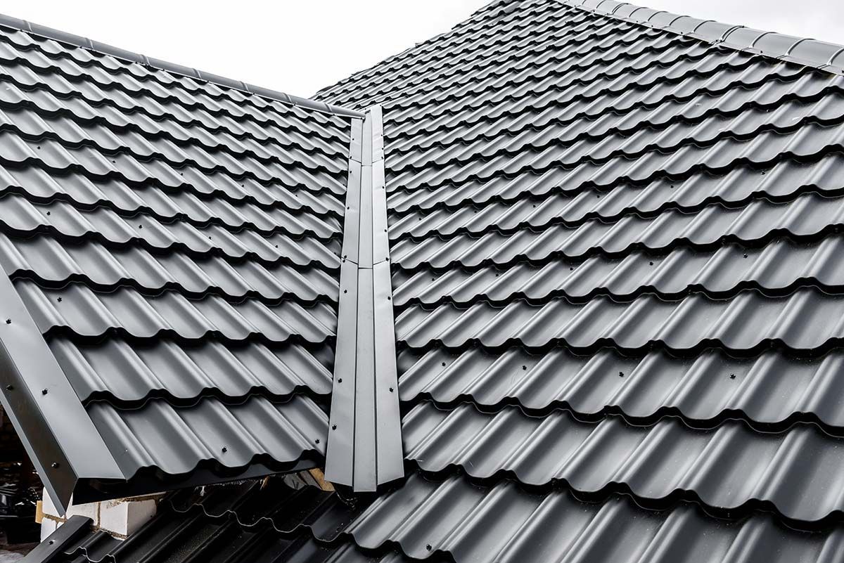 Close-up of asphalt shingle roof. A circled area with white paint around a hole.