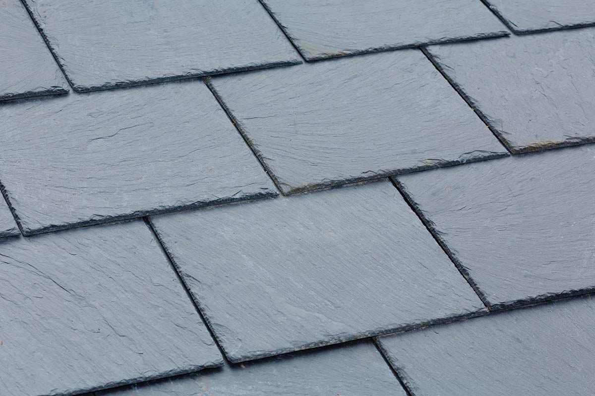 Dark gray slate roof tiles arranged in overlapping rows.