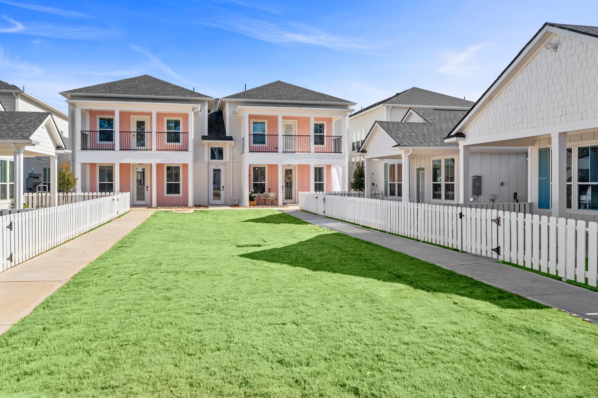 Cottage-style rental homes with fenced outdoor space at Boardwalk Village in Conroe, TX