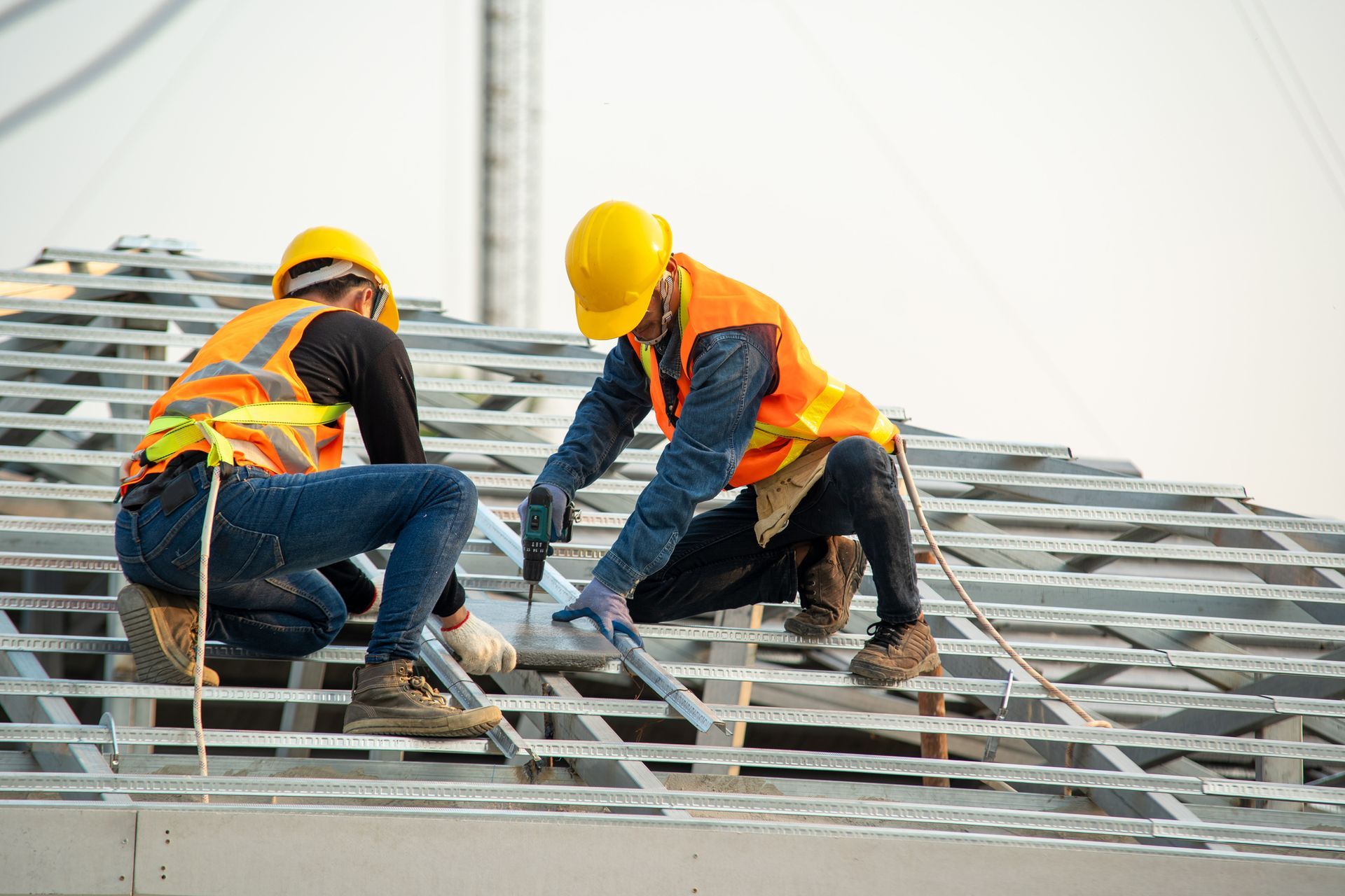 Workers Drilling On Roof — Belleville, MI — Discount Roofing