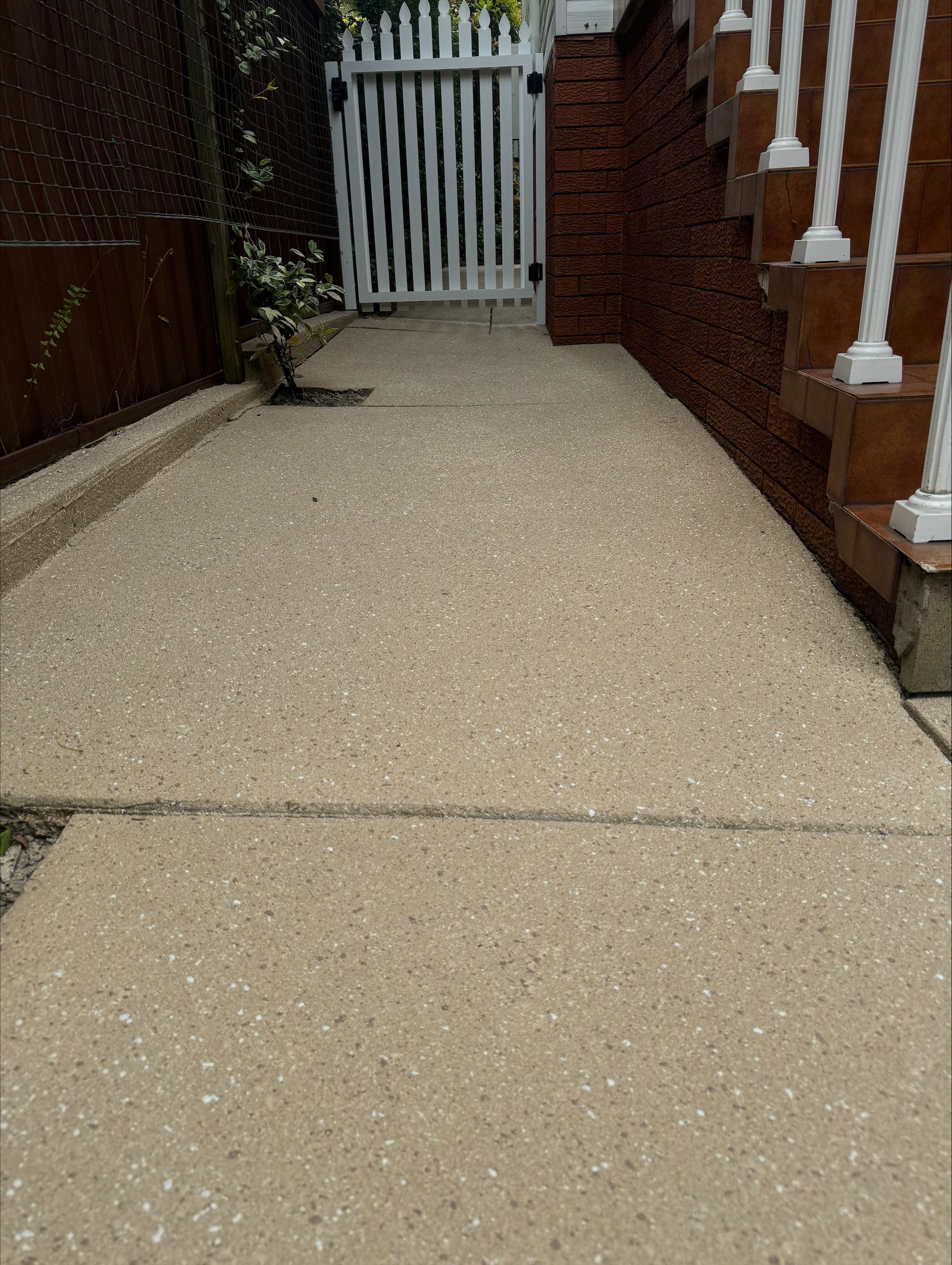 A Covered Walkway with Stairs Leading up To a Building — Illawarra Resurfacing Pty Ltd in Thirroul, NSW